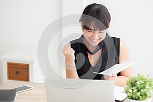 Beautiful young asian woman working laptop computer at office, businesswoman looking graph diagram analysis statistic data