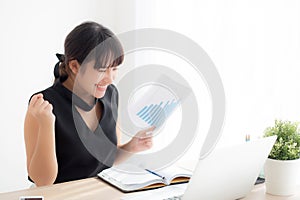 Beautiful young asian woman working laptop computer at office, businesswoman looking graph diagram analysis statistic data