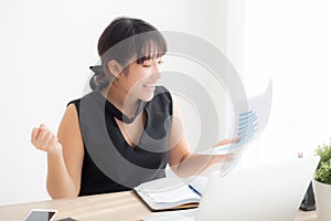 Beautiful young asian woman working laptop computer at office, businesswoman looking graph diagram analysis statistic data