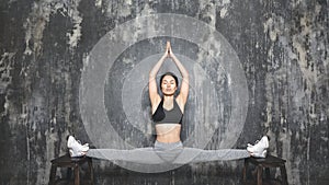 Beautiful young asian Woman Working Out, doing Pilates Exercise in Sportswear. Splits with Yoga Asana, Stretching