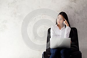 Beautiful young asian woman working and thinking with problem to stress and unhappy