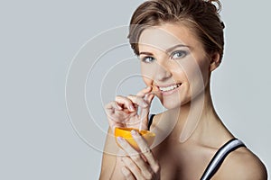 Beautiful young athletic girl energetic happy drinking orange juice, healthy lifestyle