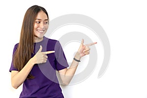 Beautiful young attractive Asian woman pointing to copy space