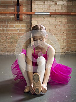 Beautiful young ballerina getting ready for class