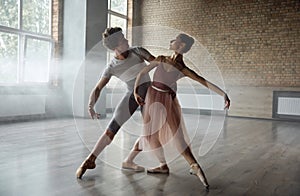 Beautiful young ballet dancers performing choreographic art