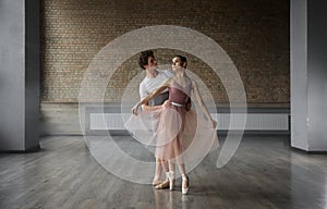 Beautiful young ballet dancers performing choreographic art