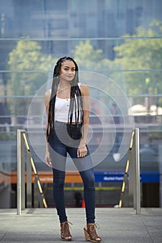 Beautiful young biracial woman poses for photo in city