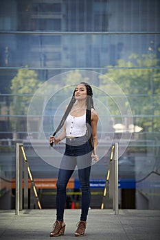 Beautiful young biracial woman poses for photo in city