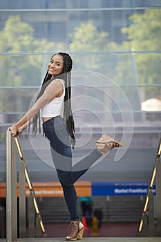 Beautiful young biracial woman poses for photo in city