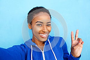 Beautiful young black fashion woman smiling against red wall