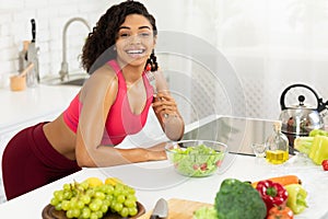 Beautiful young black girl eating vegetable salad