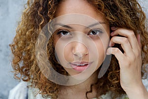 Beautiful young black woman with hand in hair