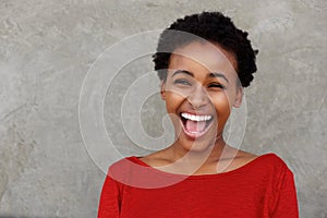 Beautiful young black woman laughing with open mouth