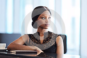 Beautiful young black woman looking away from the camera