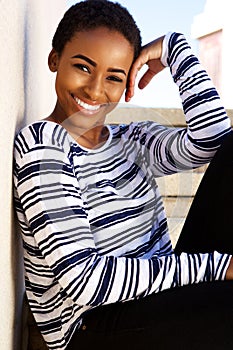 Beautiful young black woman smiling outside