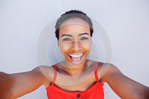 Beautiful young black woman smiling and taking selfie