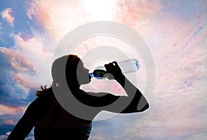 Beautiful young blond girl drinking water