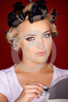 Beautiful young blond with her hair in curlers