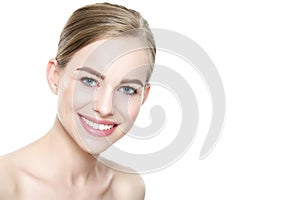 Beautiful young blond smiling woman with clean skin, natural make-up and perfect white teeth