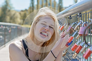 Beautiful young blond woman holding padlocks