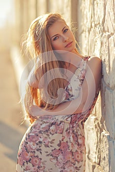 Beautiful young blond woman outdoors portrait near the sea