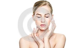 Beautiful Young Blond Woman with Perfect Skin touching her face. Facial treatment. Cosmetology, beauty and spa concept.