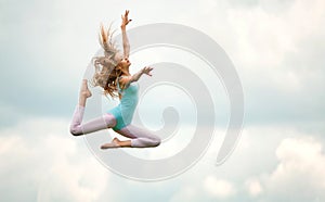 Beautiful Young Blonde in Blue Gimnastic Leotard Jumping