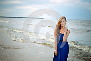 Beautiful young blonde girl on the beach