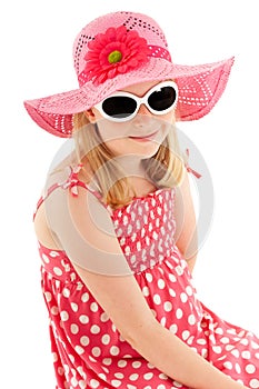 Beautiful young blonde girl in big pink floppy hat, polka dot dress and classy white framed sunglasses. Isolated on white studio