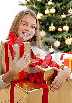 Beautiful young blonde girl holds presents