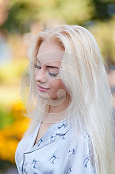 Beautiful young blonde girl with a pretty face and beautiful smiling eyes. Portrait of a woman with long hair and amazing looks.