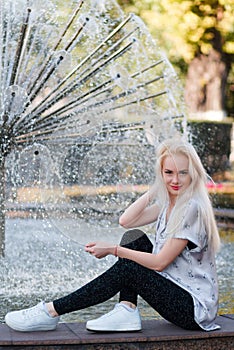 Beautiful young blonde girl with a pretty face and beautiful smiling eyes. Portrait of a woman with long hair and amazing looks.