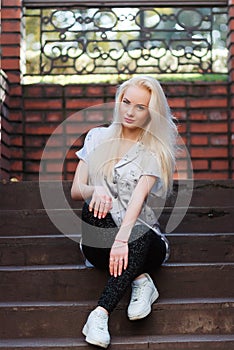 Beautiful young blonde girl with a pretty face and beautiful smiling eyes. Portrait of a woman with long hair and amazing looks.