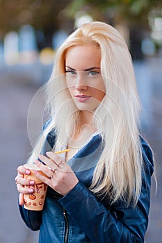 Beautiful young blonde girl with a pretty face and beautiful smiling eyes. Portrait of a woman with long hair and amazing looks.