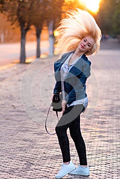 Beautiful young blonde girl with a pretty smiling face and beautiful eyes. Portrait of a woman with long hair and amazing look.