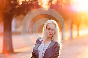 Beautiful young blonde girl with a pretty smiling face and beautiful eyes. Portrait of a woman with long hair and amazing looks.