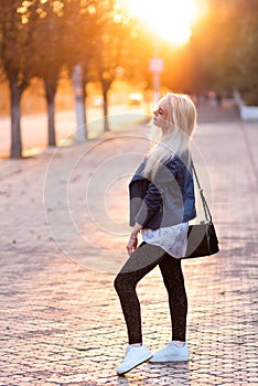 Beautiful young blonde girl with a pretty smiling face and beautiful eyes. Portrait of a woman with long hair and amazing looks.