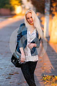 Beautiful young blonde girl with a pretty smiling face and beautiful eyes. Portrait of a woman with long hair and amazing looks.