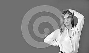 Beautiful young blonde girl with trendy accessories posing in studio. Perfect make-up.