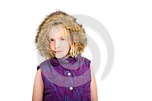 Beautiful young blonde girl wearing a fur lined hood on a white studio background