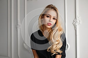 Beautiful young blonde model girl with red lips