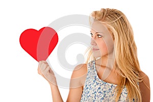 Beautiful young blonde woman with blue eyes holding red hart ban