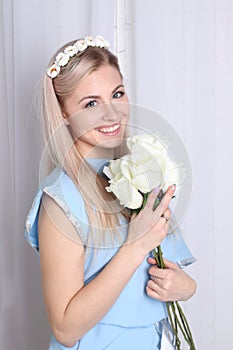 Beautiful young blonde woman with flower wreath