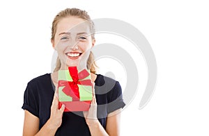 Beautiful young blonde woman holding gift over isolated background with surprise face pointing finger to himself,copy space