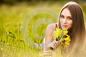 Beautiful young blonde woman on the meadow