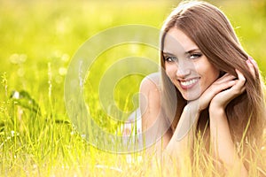 Beautiful young blonde woman on the meadow