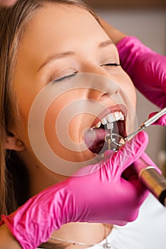 Beautiful young blonde women at dentist, dental care