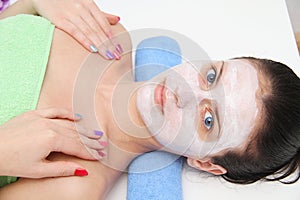 Beautiful young blue eye woman with clay facial mask