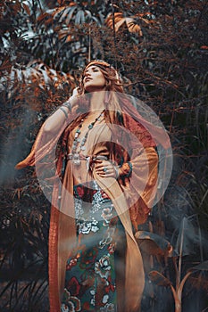 Beautiful young boho gypsy style woman outdoors photo