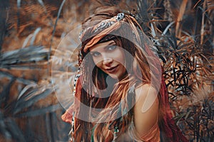 Beautiful young boho gypsy style woman outdoors portrait photo